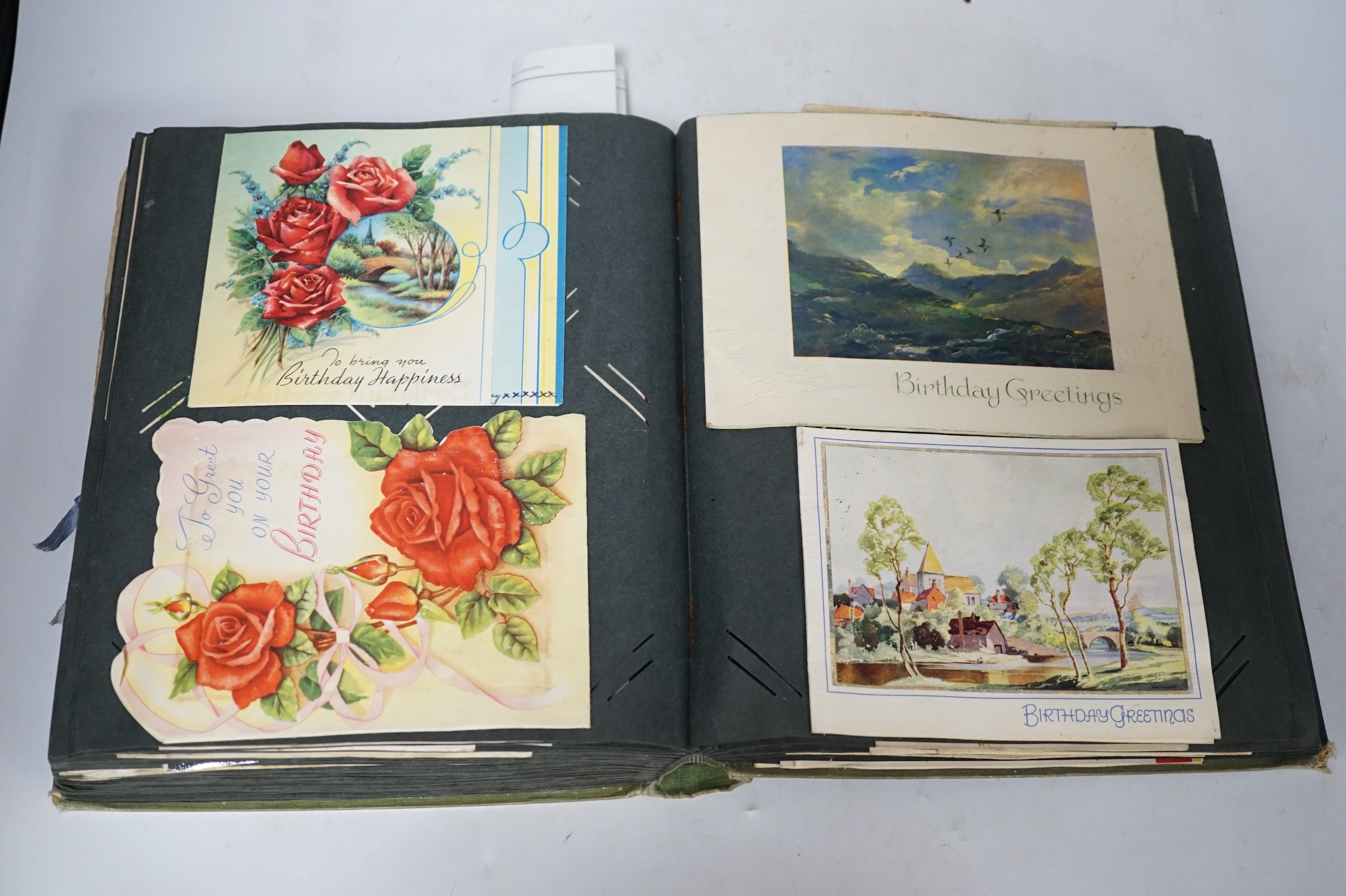 A vintage postcard album including greetings cards. Condition - fair